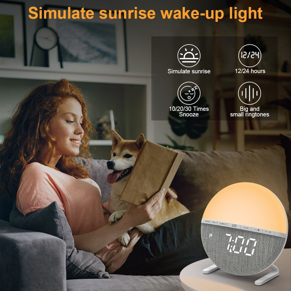 Woman reading to a dog on a couch with a sunrise simulation alarm clock.