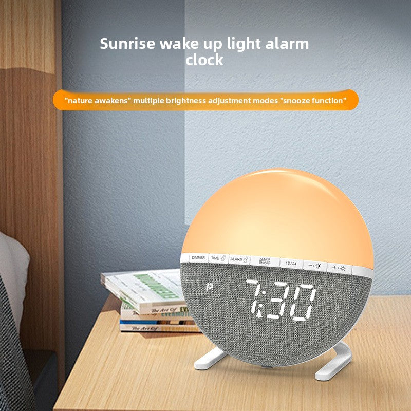 Circular sunrise alarm clock glowing orange and yellow on a minimalist bedside table.